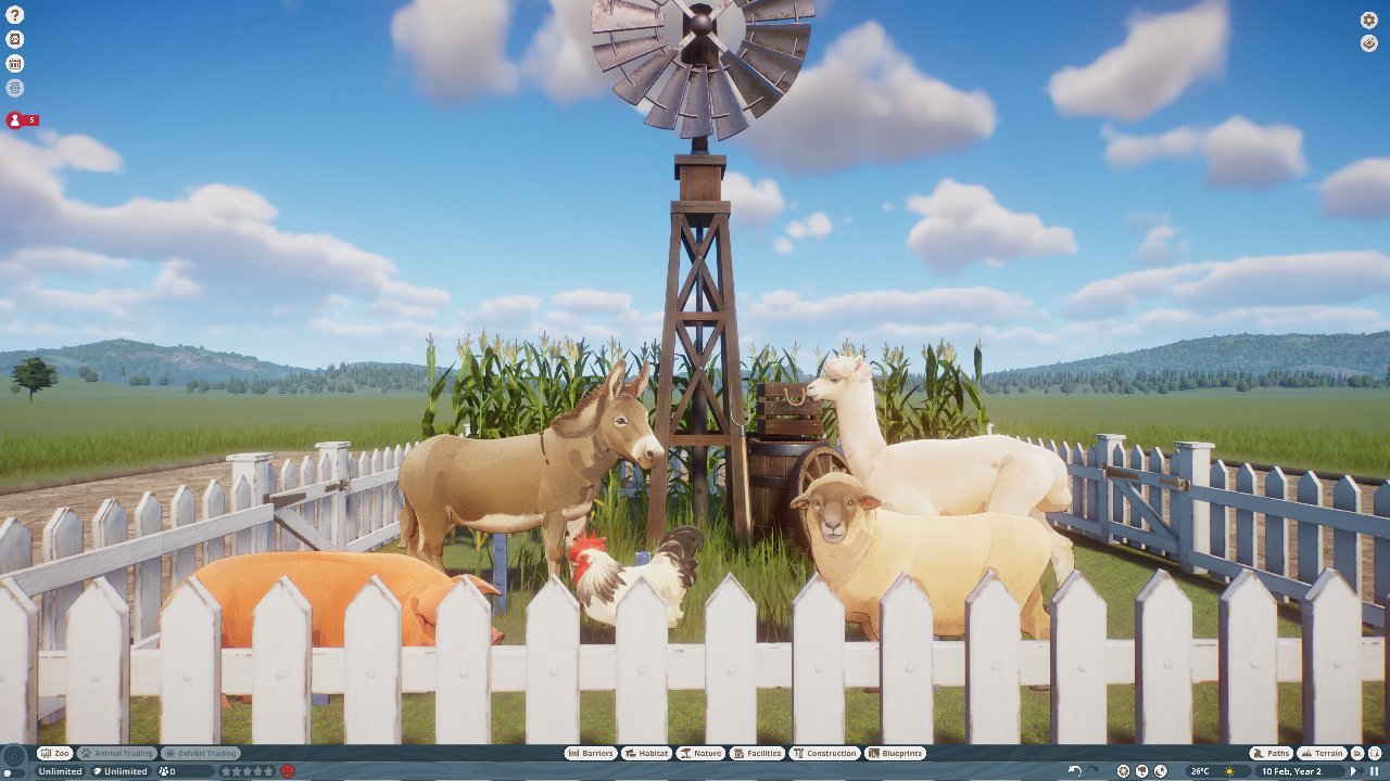 Farm animals behind wooden fence